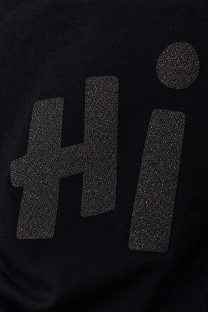 Close view of the Hi glitter print on black cotton