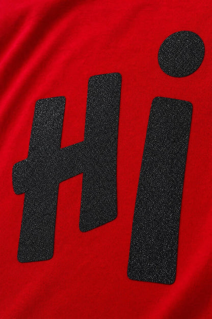 Close view of the Hi glitter print on red cotton