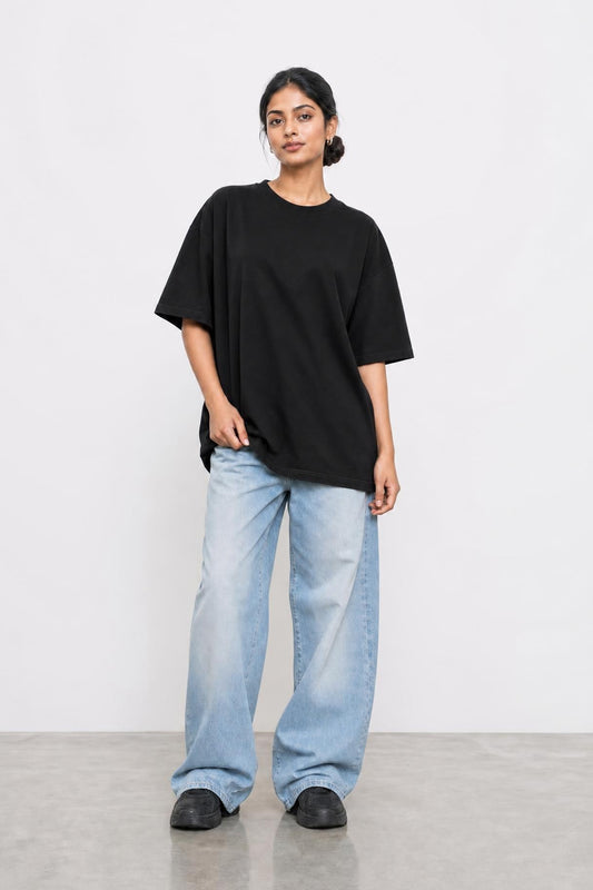 Plain oversized tee in black, front view on her