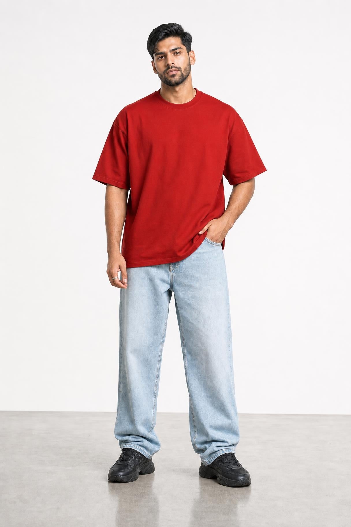 Plain oversized tee in red, front view on him