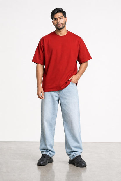 Plain oversized tee in red, front view on him