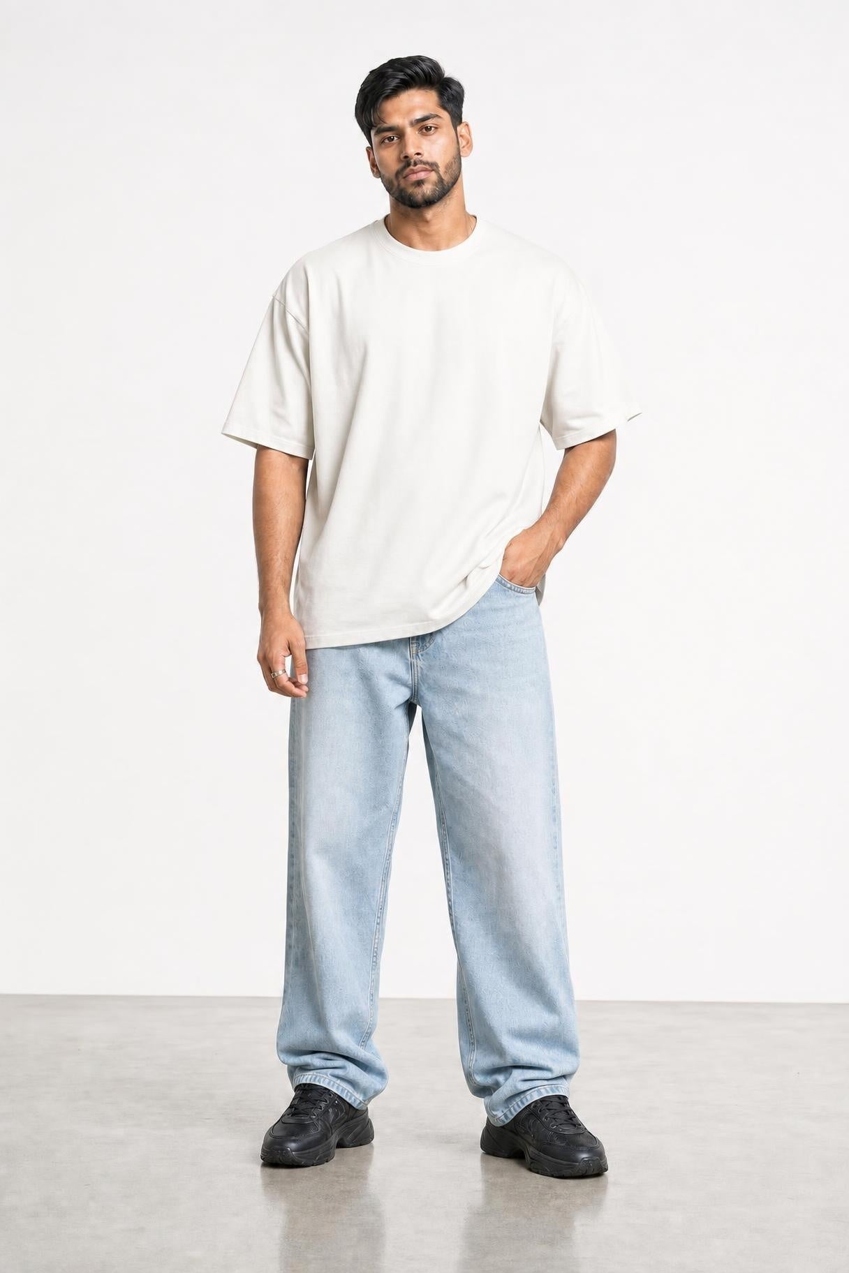 Plain oversized tee in white, front view on him