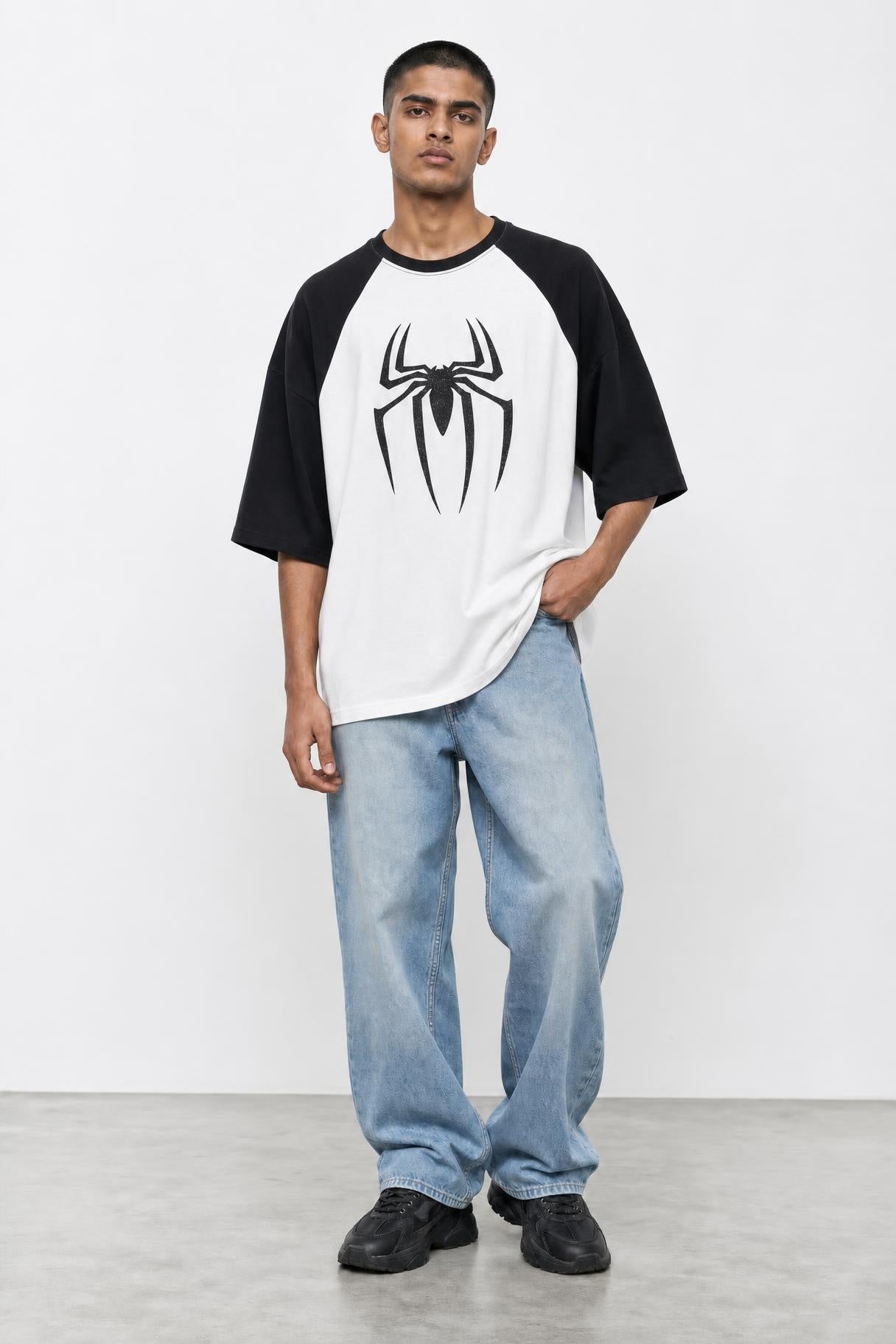 Spider glitter raglan tee with black sleeves, front view on him