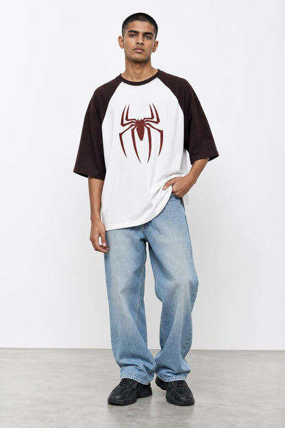 Spider glitter raglan tee with maroon sleeves, front view on him