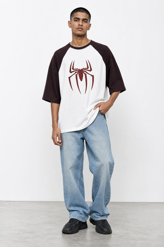 Spider glitter raglan tee with maroon sleeves, front view on him