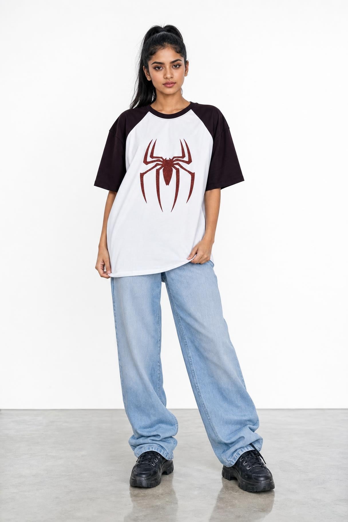 Spider glitter raglan tee with maroon sleeves, front view on her